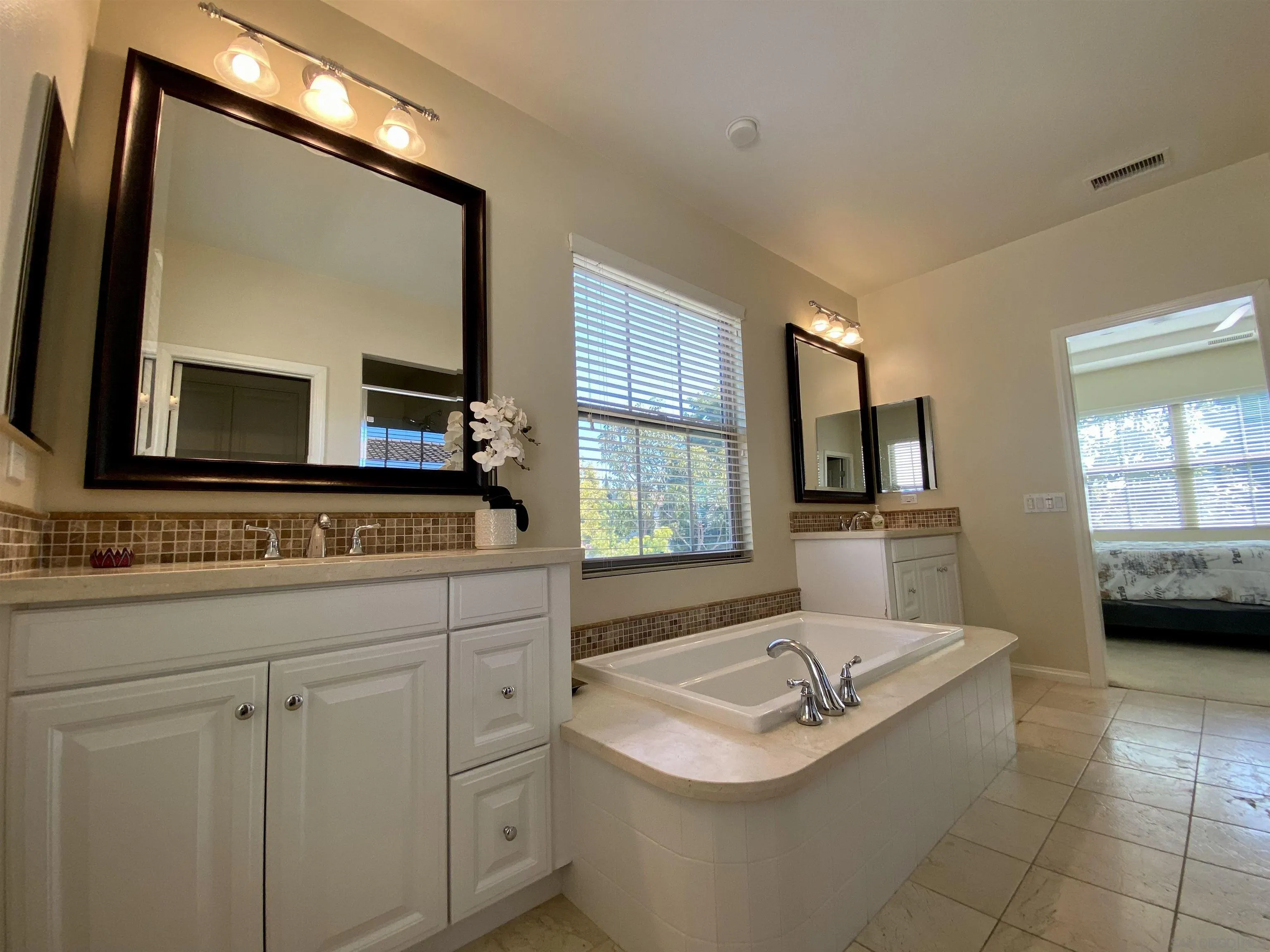 45 Diamond Irvine, CA 92620 - Photo 13 of 16 a bathroom with a sink a mirror and a bathtub