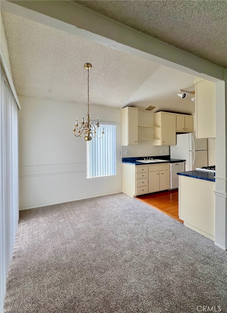 1350 Cabrillo Park Drive, Unit F Santa Ana, CA 92701 - Photo 13 of 32 a view of a kitchen with a sink oven cabinets and a window