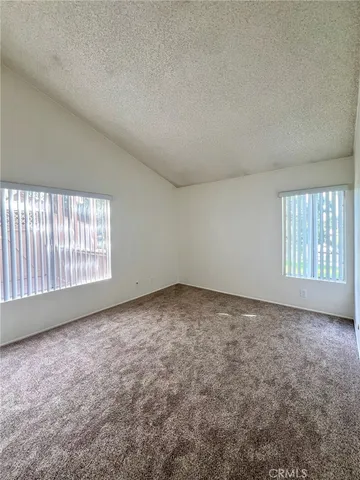 a bathroom with a granite countertop toilet sink and mirror