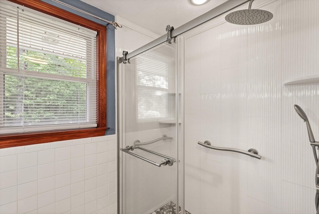 901 Haverhill Street Rowley, MA 01969 - Photo 30 of 42 a bathroom with a shower and a window