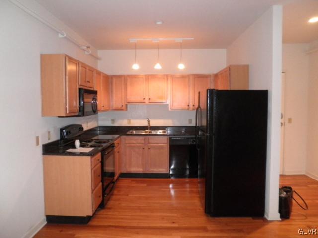 11 West 2nd Street, Unit 381 Bethlehem, PA 18015 - Photo 3 of 10 a kitchen with stainless steel appliances granite countertop a refrigerator and a stove top oven