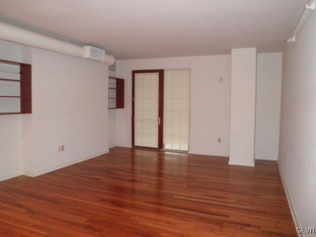 11 West 2nd Street, Unit 381 Bethlehem, PA 18015 - Photo 4 of 10 a view of an empty room with wooden floor and a window
