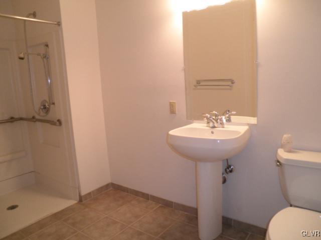 11 West 2nd Street, Unit 381 Bethlehem, PA 18015 - Photo 7 of 10 a bathroom with a sink toilet and a mirror