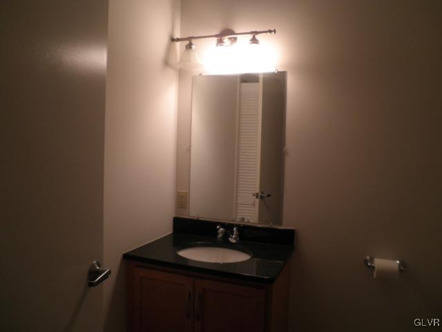 11 West 2nd Street, Unit 381 Bethlehem, PA 18015 - Photo 8 of 10 a bathroom with a granite countertop sink and mirror