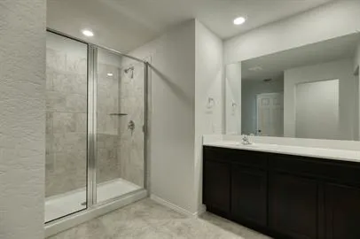 a bathroom with a shower sink and mirror