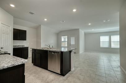720 Taggart Trail Jarrell, TX 76537 - Photo 2 of 12 a large kitchen with kitchen island granite countertop a sink and a stove top oven