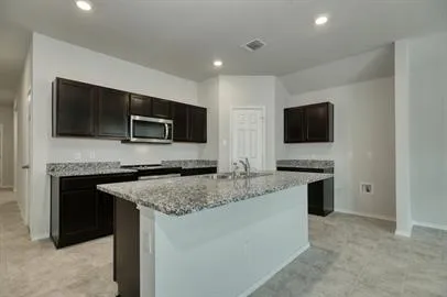 a kitchen with a granite counter tops and a stove