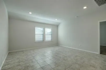 an empty room with a empty space and windows