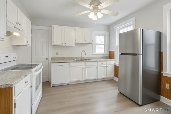 a kitchen with a refrigerator a sink and dishwasher