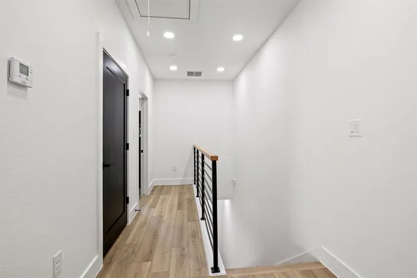 a view of hallway with wooden floor