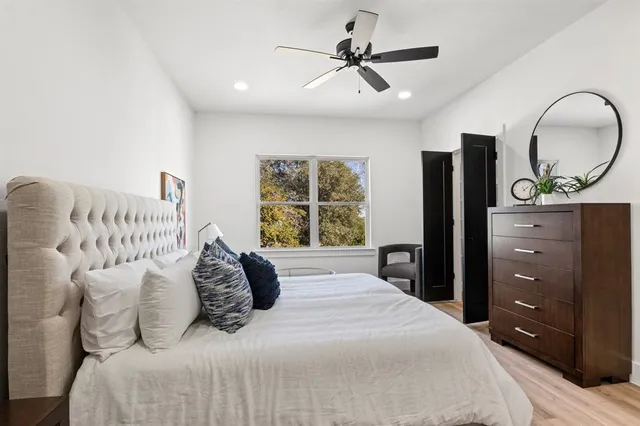 a bedroom with a bed and painting on the wall