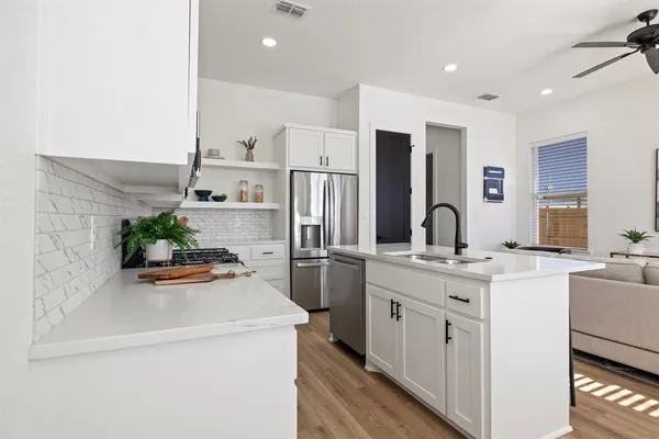a kitchen with a sink and a refrigerator with a sink