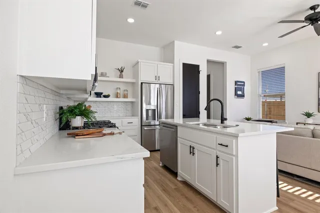 a kitchen with a sink and a refrigerator with a sink