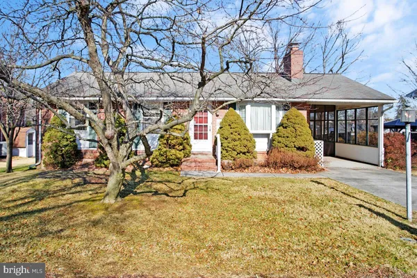 a view of a house with large trees