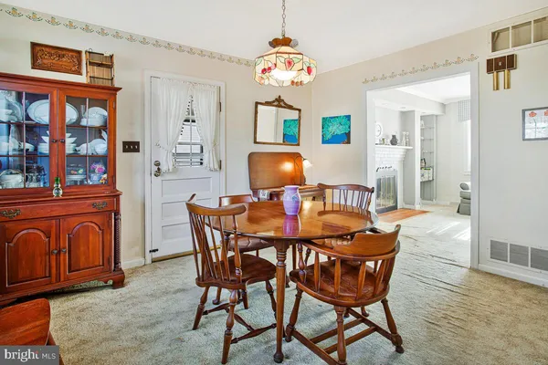 a dining room with furniture and wooden floor
