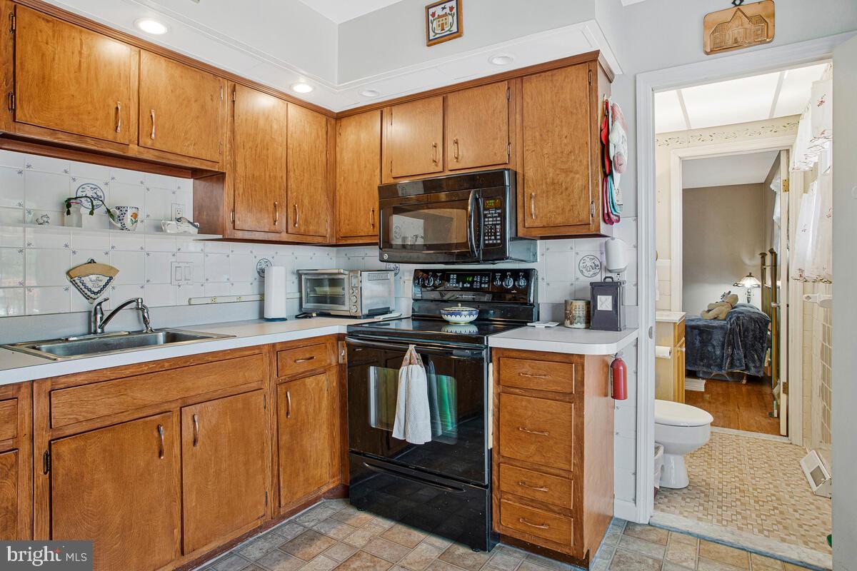 612 Fairmount Road Linthicum Heights, MD 21090 - Photo 12 of 46 a kitchen with stainless steel appliances granite countertop a stove sink and cabinets