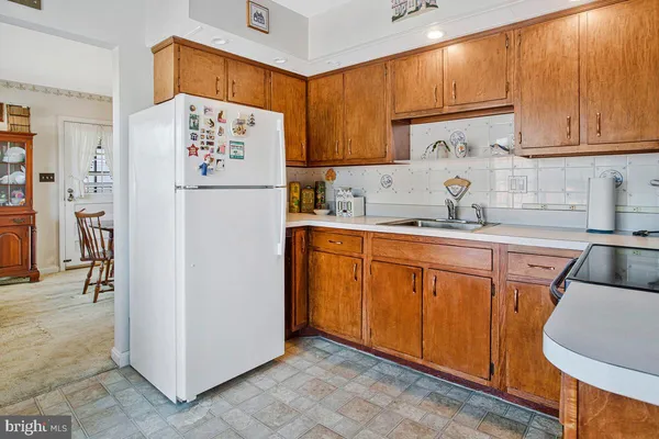 a kitchen with stainless steel appliances granite countertop a refrigerator sink and cabinets