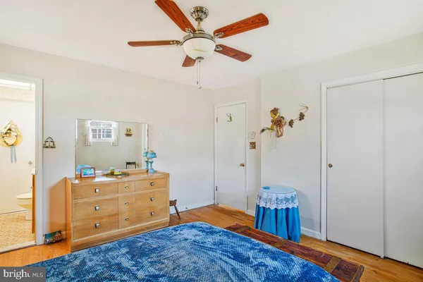 a bedroom with a bed and a dresser in it