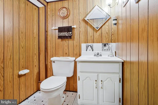 a bathroom with a sink a toilet and shower curtain
