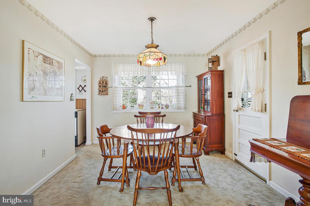 612 Fairmount Road Linthicum Heights, MD 21090 - Photo 9 of 46 a dining room with furniture a chandelier and window