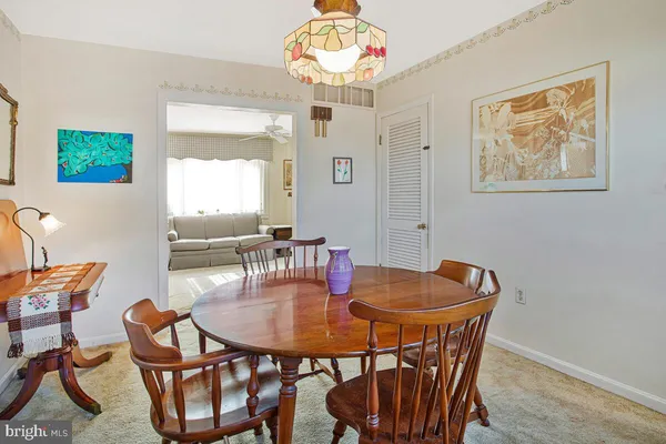 a dining room with furniture and window