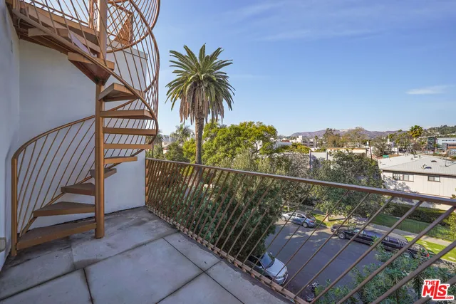 a view of a roof deck with wooden fence and floor