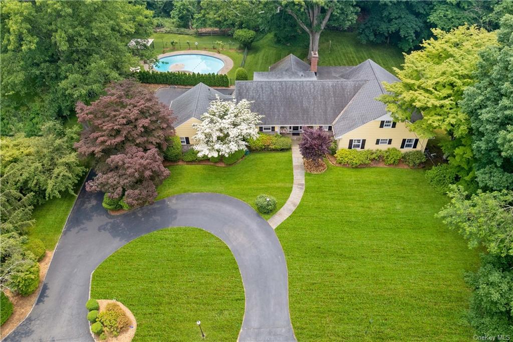 a aerial view of a house with a garden and swimming pool