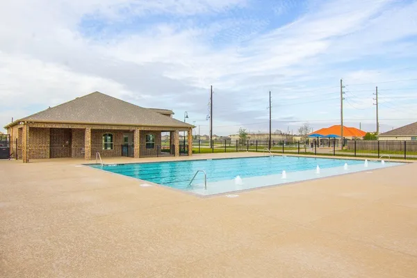 a view of an house with swimming pool and yard