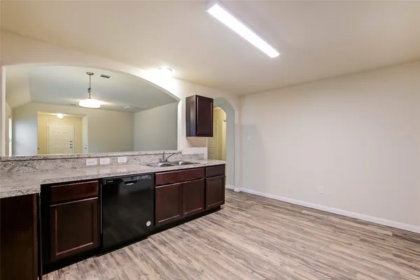 a spacious bathroom with a granite countertop sink and a mirror