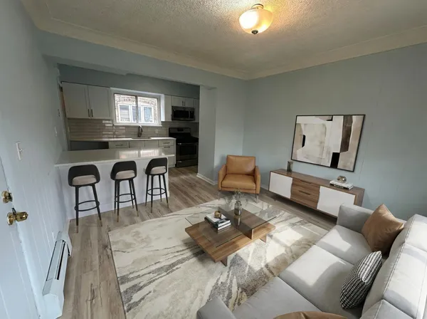 a living room with furniture and a wooden floor