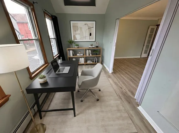 a view of a workspace with furniture and bathroom