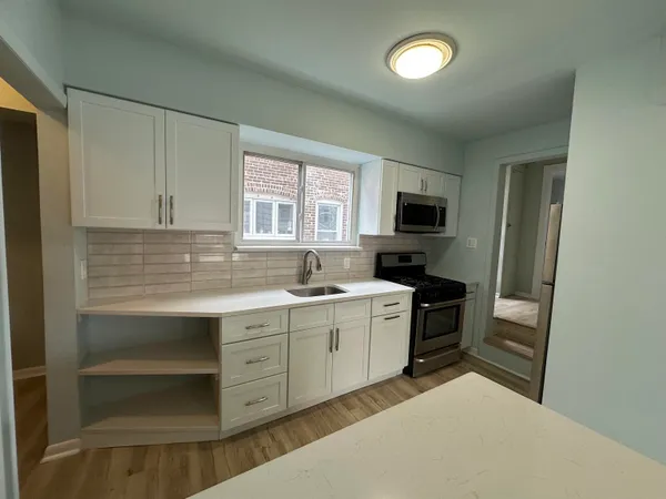 a kitchen with a sink stove and microwave