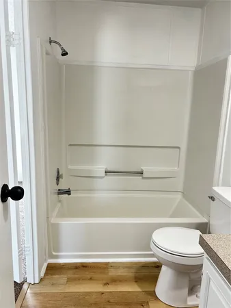 a bathroom with a toilet and a shower