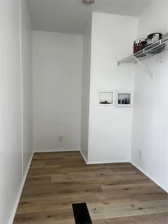 a view of a room with wooden floor