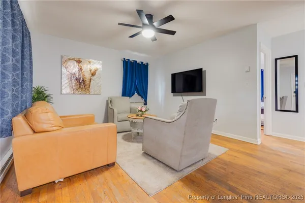 a living room with furniture and a flat screen tv