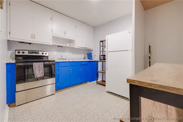 a kitchen with stainless steel appliances granite countertop a refrigerator stove a sink and dishwasher