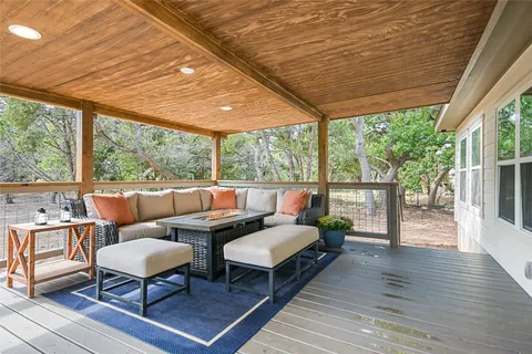 a backyard of a house with table and chairs