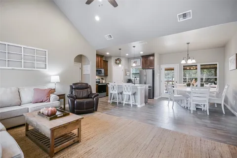 a view of a dining room with furniture wooden floor and chandelier