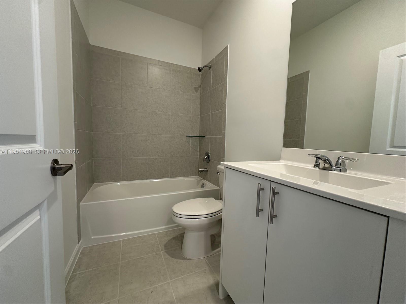 29229 Southwest 162nd Court Homestead, FL 33033 - Photo 14 of 27 a bathroom with a granite countertop sink toilet and bathtub