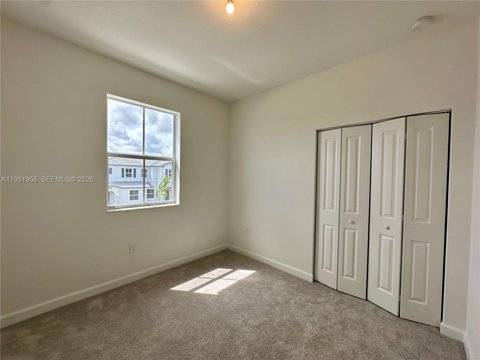 29229 Southwest 162nd Court Homestead, FL 33033 - Photo 19 of 27 an empty room with windows