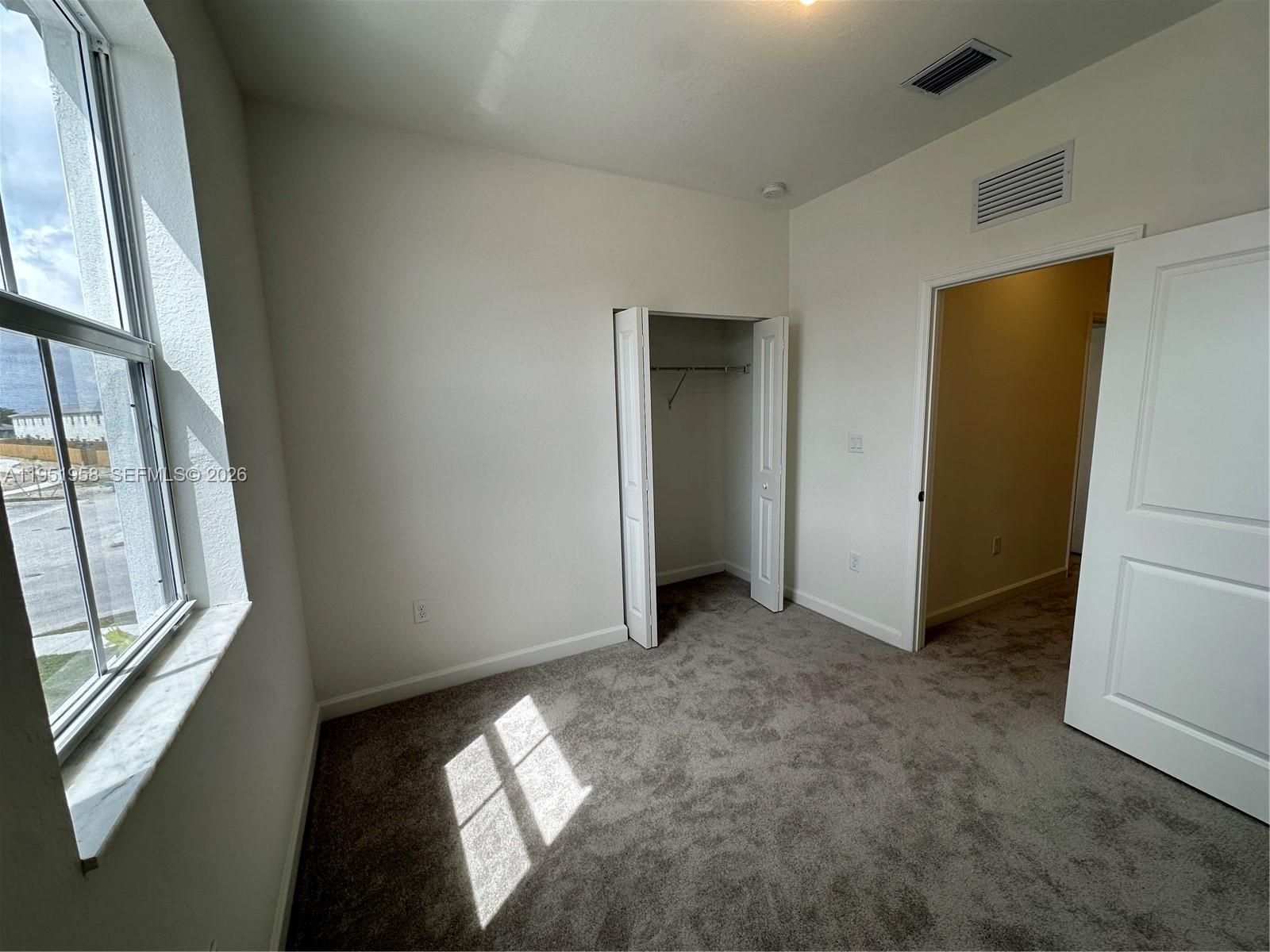 29229 Southwest 162nd Court Homestead, FL 33033 - Photo 20 of 27 an empty room with windows