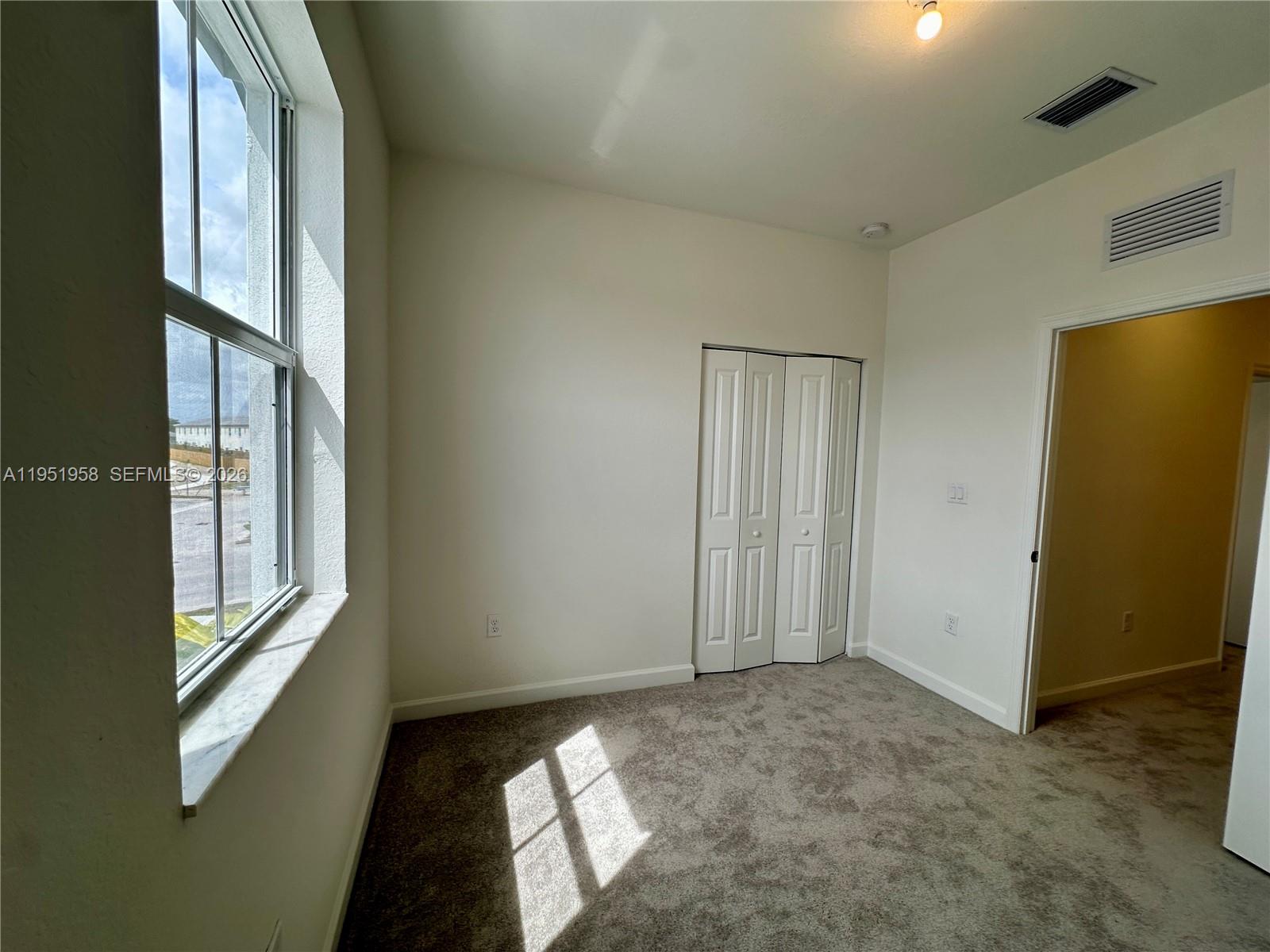29229 Southwest 162nd Court Homestead, FL 33033 - Photo 25 of 27 a view of an empty room and window