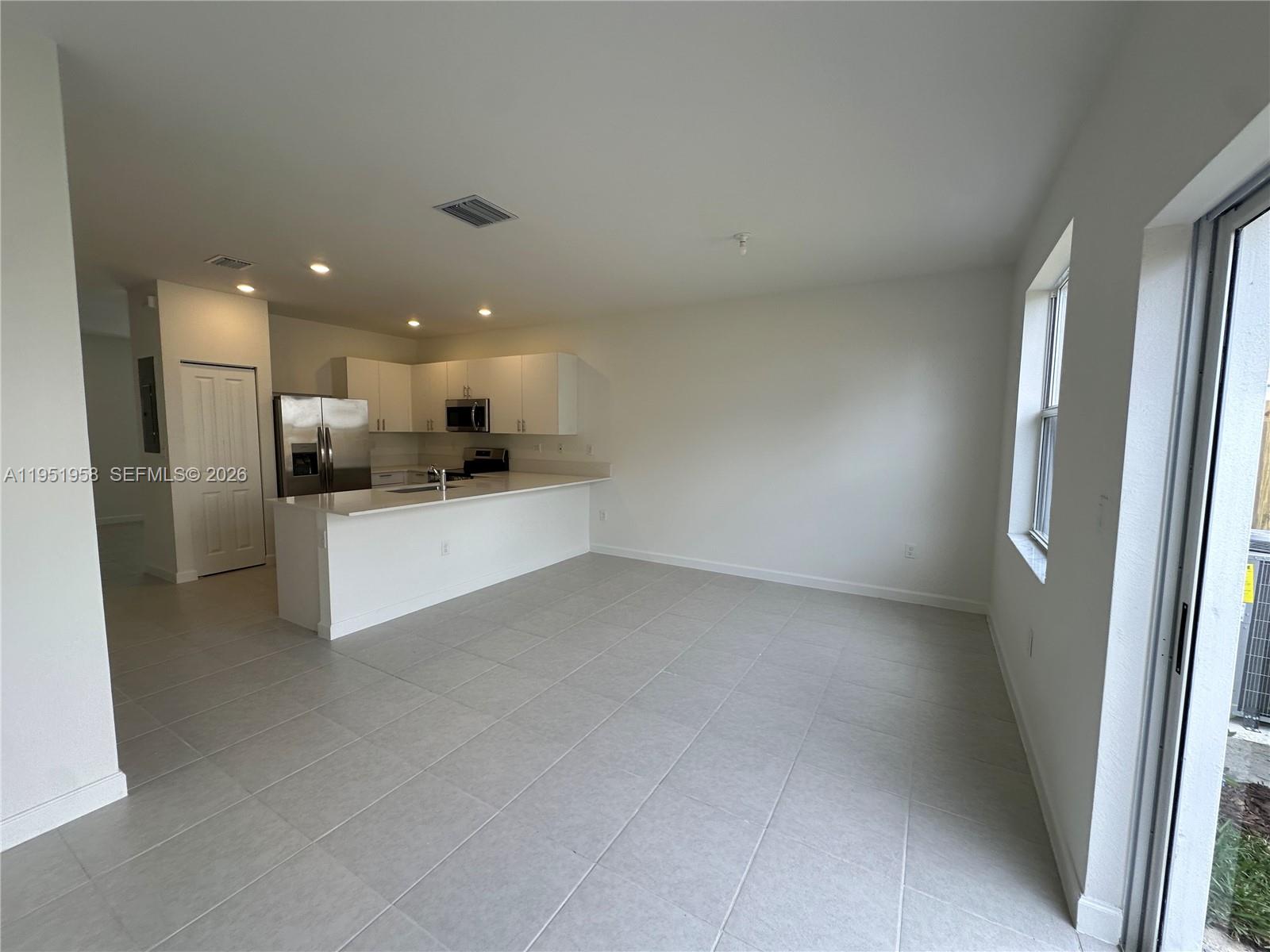 29229 Southwest 162nd Court Homestead, FL 33033 - Photo 6 of 27 a view of a kitchen with refrigerator and windows