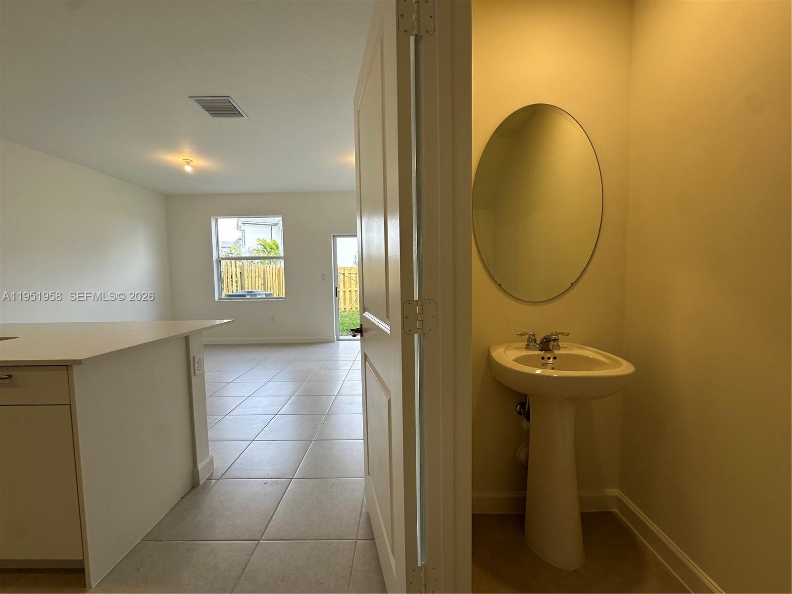 29229 Southwest 162nd Court Homestead, FL 33033 - Photo 8 of 27 a view of a bathroom with a sink and mirror