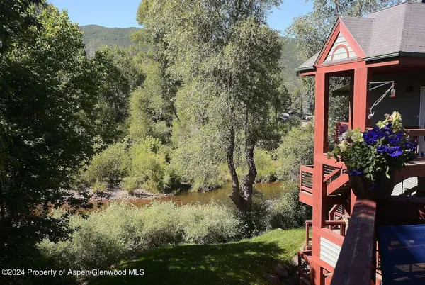 a living room with fireplace furniture and a large window