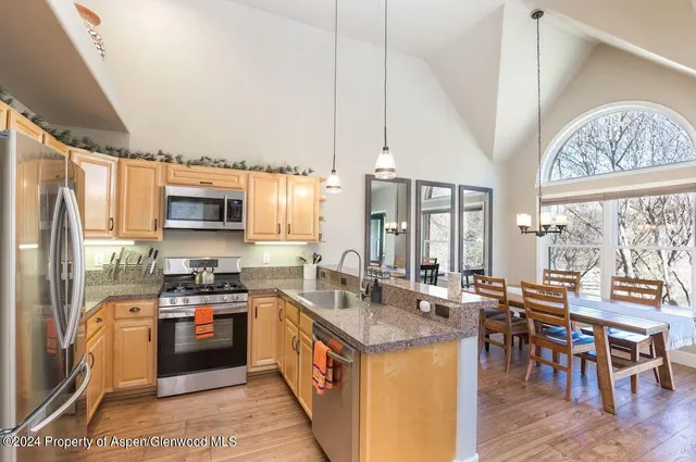a large bed sitting in a bedroom next to a window