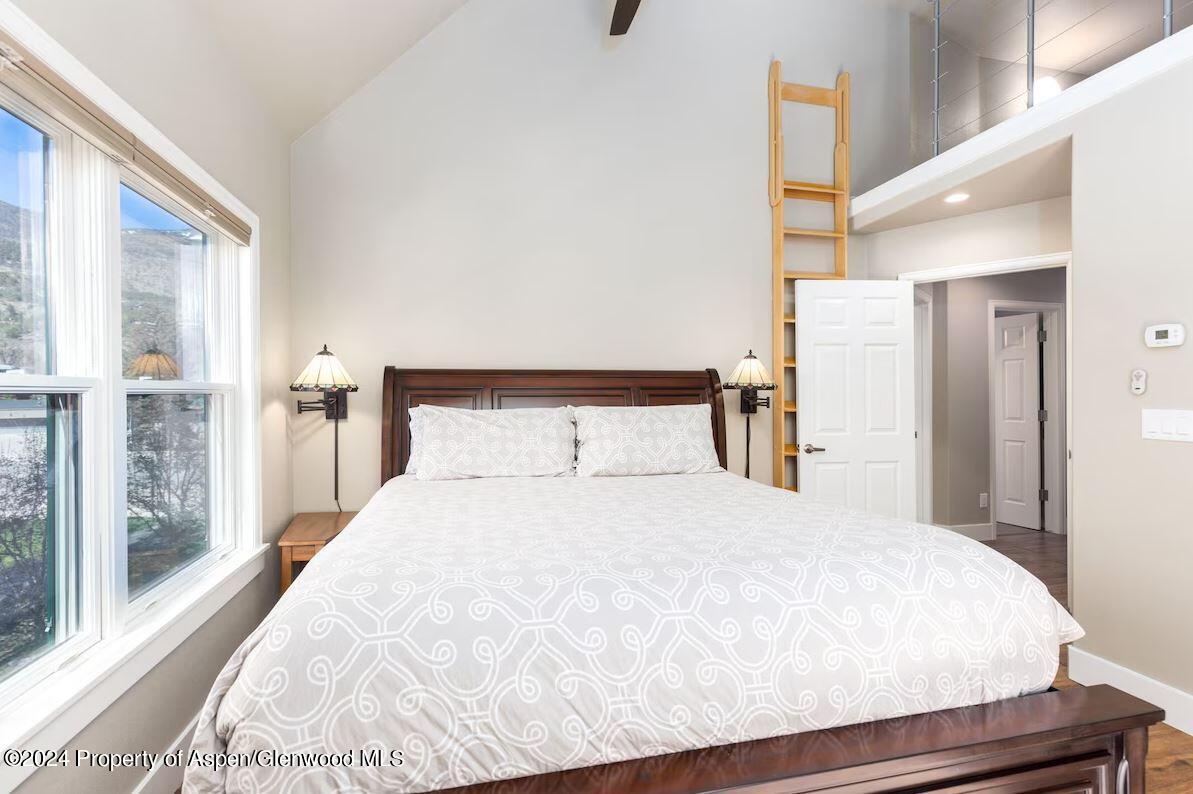855 Gold Rivers Court, Unit 21D Basalt, CO 81621 - Photo 6 of 12 a large bed sitting in a bedroom next to a window