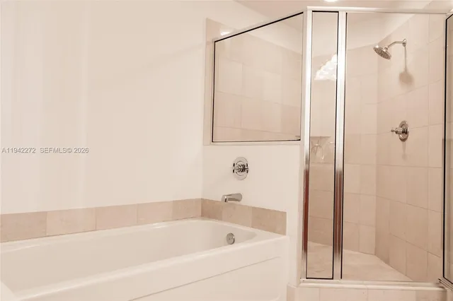 a bedroom with a bed and a large window with outer view