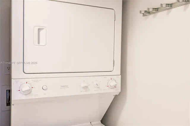 a living room with furniture and floor to ceiling windows