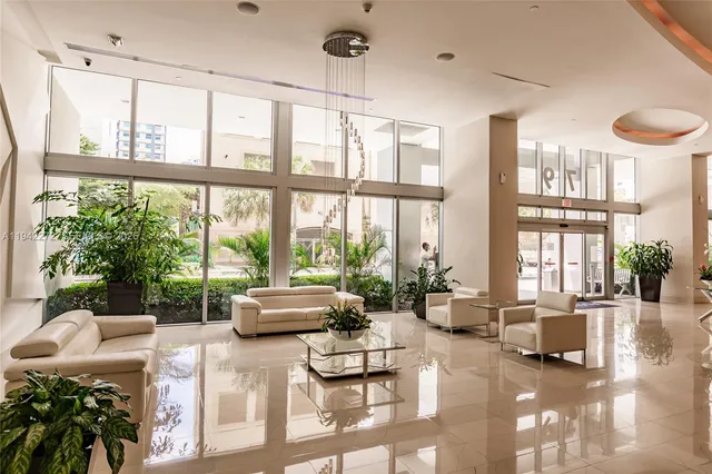 a living room with furniture and floor to ceiling window